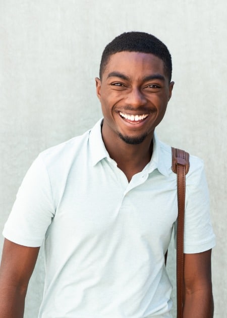 smiling young african american man walking with shoulder bag.jpg s=1024x1024&w=is&k=20&c=WM3FTnBKd7UbI 9rwTur5AYvLngA5 wscCGBuXwUY I=